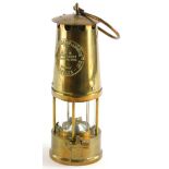 A brass protector miner's lamp, 25cm high.