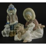 Three Lladro porcelain figures, to include two Eskimo children with polar bears, and a recumbent ang