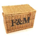 A Fortnum and Mason wicker hamper, with leather straps, 55cm wide.