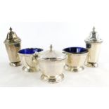 A 20thC silver cruet, comprising two open salts with blue glass liners (one AF), two pepper pots and