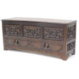 A late 19thC stained oak mule chest, the hinged top carved with lozenges and with a moulded border,