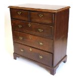 An early 19thC oak chest of drawers, the top with a moulded edge above two short and three long draw