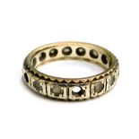 An eternity ring, set with white paste stones in a white metal setting, unmarked, ring size M½, 3.6g