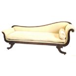 A George IV simulated rosewood show frame chaise longue, upholstered in beige fabric, carved with sc