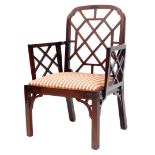 A George III mahogany Cockpen chair, with a shaped back and arms each with a lattice insert, with a