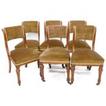 A set of six early Victorian oak dining chairs, each with a green upholstered padded back and seat o