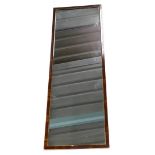 A rectangular wall mirror, with a gesso frame painted to simulate rosewood 115cm x 39cm.