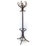 A stained beech bentwood hallstand, with central pole, shaped hooks and umbrella base, 205cm high.
