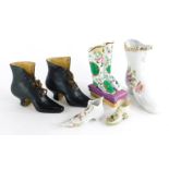 A pair of 19thC continental ceramic laced boots, a Paris porcelain pair of boots, (AF), and another