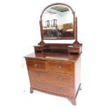 An Edwardian mahogany and chequer banded dressing table, the raised back with an arched bevelled pla