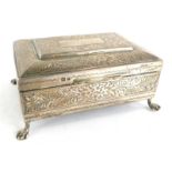 An Edward VII silver jewellery casket, decorated profusely with flowers, scrolls, leaves, etc., with