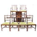 A set of six mahogany ladder back dining chairs in George III style, each with a green padded seat o