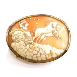 A late 19thC shell cameo brooch, the cameo depicting figure in chariot with two horses, in a gold pl