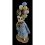 A Lladro porcelain figure of a balloon seller, on an ovoid base, printed mark in blue to underside,