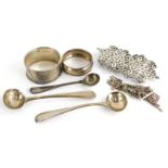 A collection of small silver, to include three salt spoons, two napkin rings, an Edwardian two piece