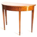 A satinwood and ebony strung demi lune console table, with a crossbanded top on square tapering legs
