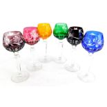A harlequin set of six Bohemian style port glasses, each with a coloured cut glass bowl.