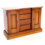 A Victorian mahogany small cabinet, modelled in the form of a wardrobe or clothes press, with two pa