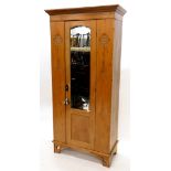 A late 19th/early 20thC pine Art Nouveau style wardrobe, with a moulded oak cornice, above a single