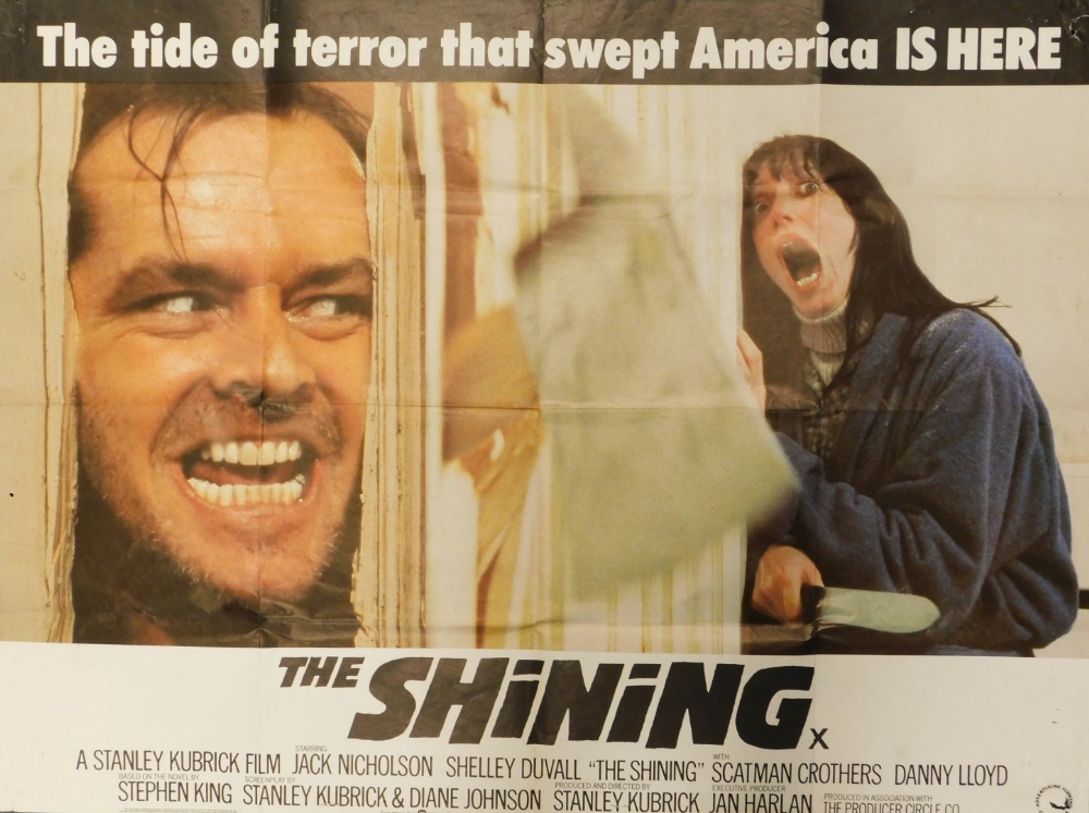 A film poster for the Stanley Kubrick film The Shining, with slogan The Tide of Terror That Swept Am