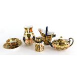 A collection of Royal Crown Derby miniature porcelain, each decorated in Imari colours, to include t