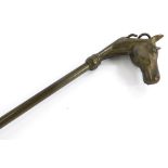 A brass shoe horn, the handle cast with a racehorse, 47cm long.