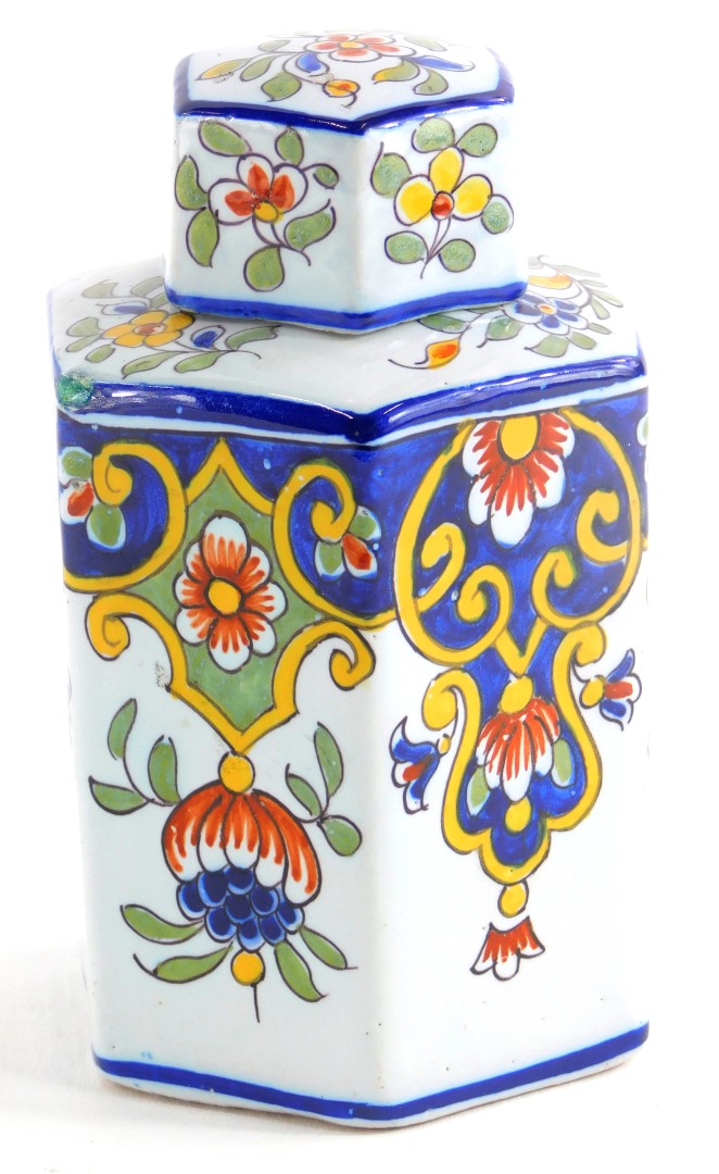 A French faience octagonal tea caddy and lid, decorated overall with flowers, scrolls, leaves, etc.,