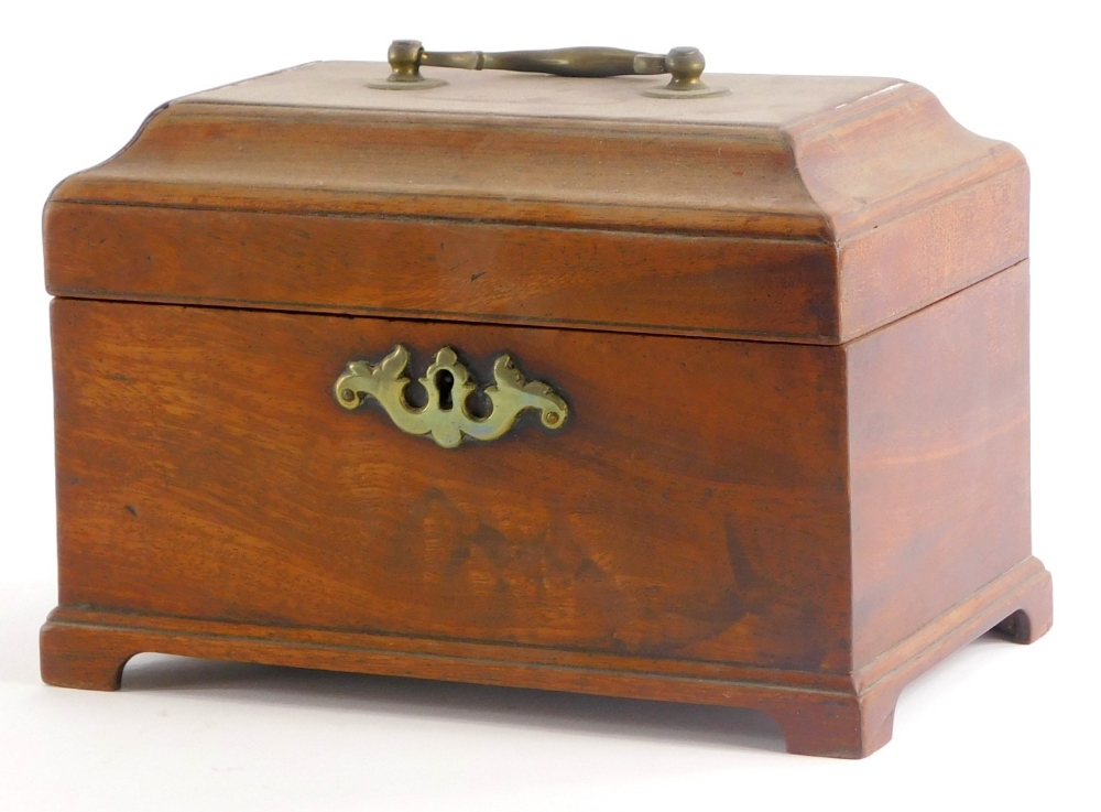 A George III mahogany tea caddy, the domed lid with a brass swing handle, enclosing a vacant interio