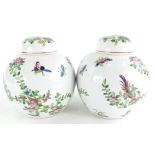 A pair of Chinese porcelain ginger jars and covers, each decorated with famile rose enamels, printed