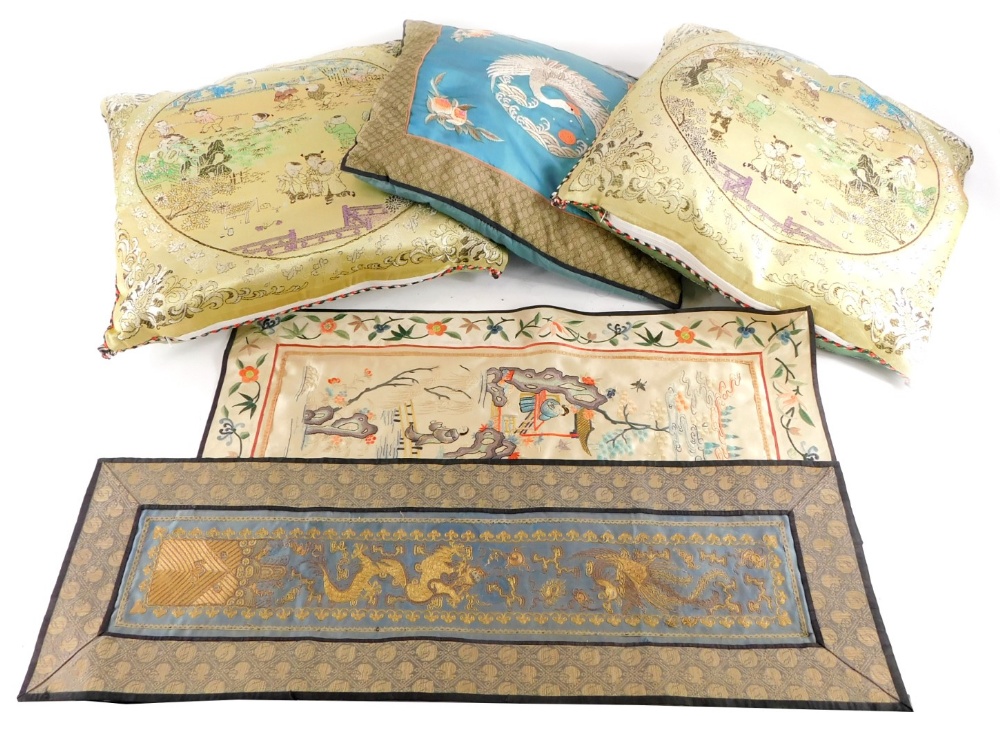 Three oriental embroidered cushions, and two embroidered panels (modern).