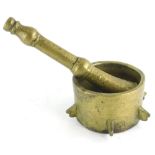 A brass pestle and mortar, the circular mortar of drum form, the pestle with turned decoration, poss