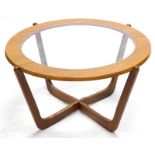 A G-Plan type teak coffee table, the circular top with a smoked glass insert, on X shaped support, 7