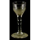 A late 18th/early 19thC wine glass, with a rounded bowl and facet cut stem and a domed foot, 13cm h