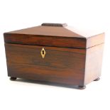 A 19thC rosewood sarcophagus shaped tea caddy, the hinged lid enclosing two lidded compartments, wit
