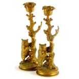 A pair of continental gilt metal candlesticks, each modelled in the form of a Black Forest type bear