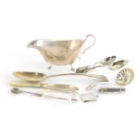 A collection of small silver, to include a gravy boat, various flatware, envelope shaped stamp case,