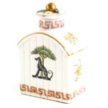 A continental porcelain tea caddy and lid, with a gilt finial and decorated with a dog and tree cres
