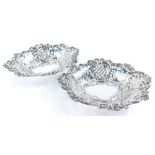A pair of pierced silver plated early 20thC bonbon dishes, with embossed decoration of flowers, scro