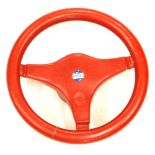 A red leather clad Ford Escort steering wheel, 33cm diameter.