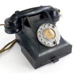 A vintage black Bakelite telephone, stamped to underside 4509B. (AF)