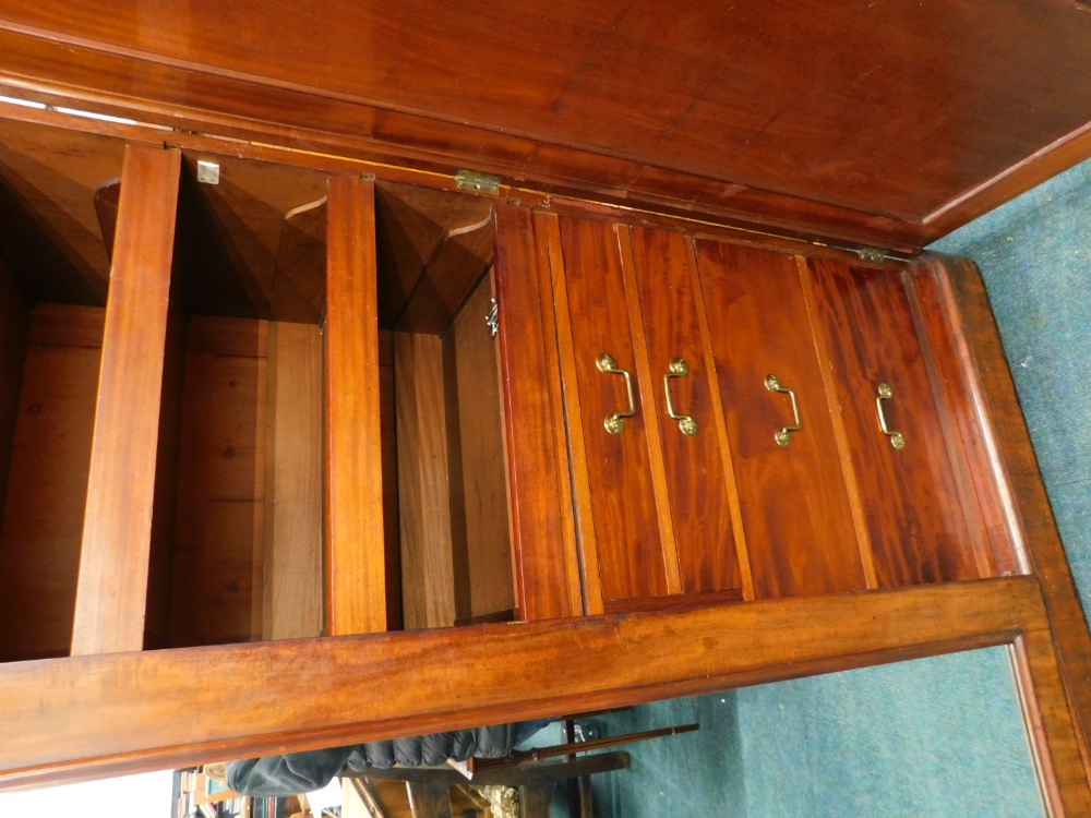 A Victorian figured mahogany triple wardrobe, with a moulded cornice above a central mirror, flanked - Image 2 of 2