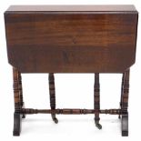 A late Victorian walnut Sutherland table, the rectangular top with canted corners on ring turned sup