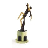 An Art Deco style resin figure of a dancer, on a black and green onyx base, 41cm high.
