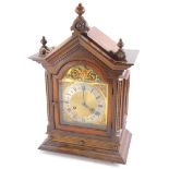 A late 19thC German mantel clock, in a walnut case with turned finals, dentil cornice above an arche