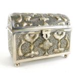 An eastern white metal casket, profusely decorated with raised abstract fish motifs and Arabic writi