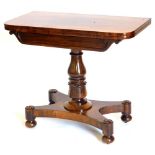 A William IV rosewood card table, the D shaped top above a scroll carved panelled frieze on a turned