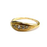 A diamond set dress ring, set with five tiny diamonds in diamond shaped ring head, in a yellow metal