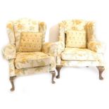 An associated pair of mahogany wingback chairs in George III style, each upholstered in gold and tur