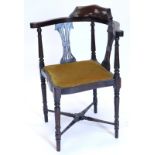 An Edwardian walnut corner chair, with two pierced splats, a padded seat, on turned tapering legs wi