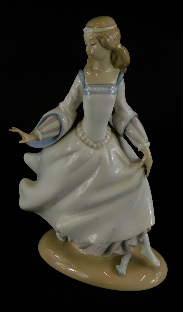 A Lladro porcelain figure of lady wearing a flowing dress, impressed no. 4828 to underside, 25cm hig